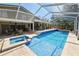 Spacious screened pool area with jacuzzi and tanning ledge provides a backyard oasis and outdoor entertaining at 2872 Hammock Dr, Plant City, FL 33566