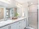 Elegant bathroom with double vanity, granite countertop, and glass-enclosed shower at 6957 161St E Ter, Parrish, FL 34219