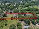 An aerial view shows the property lines, pool and house surrounded by lush greenery at 7608 Franklin Rd, Plant City, FL 33565