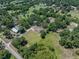 An aerial view shows the property with mature trees, and surrounding houses at 7608 Franklin Rd, Plant City, FL 33565