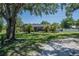 Spacious backyard showcases a screened lanai and mature trees, creating a peaceful outdoor retreat at 7608 Franklin Rd, Plant City, FL 33565