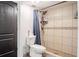 Bathroom featuring a tiled shower with a shower curtain and a dark colored door at 7608 Franklin Rd, Plant City, FL 33565
