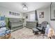 Charming Bedroom with stylish decor, featuring a crib, changing table, and comfortable seating at 7608 Franklin Rd, Plant City, FL 33565