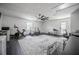 Bonus room featuring a large ceiling fan and an exercise bike next to a weight rack at 7608 Franklin Rd, Plant City, FL 33565