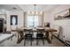 Traditional dining room features a wooden table, unique chairs, and a modern chandelier with natural light at 7608 Franklin Rd, Plant City, FL 33565