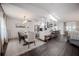 Open dining and kitchen area with dark wood floors, stainless steel appliances and a light-filled seating area at 7608 Franklin Rd, Plant City, FL 33565