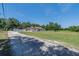 Exterior of the home with a long driveway leading up to the property with an adjacent field at 7608 Franklin Rd, Plant City, FL 33565