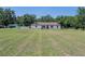 Charming single-story home featuring a bright, white exterior with a sprawling, green lawn at 7608 Franklin Rd, Plant City, FL 33565