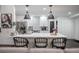 Modern kitchen with white cabinets, stainless steel appliances, pendant lighting, and an island with seating at 7608 Franklin Rd, Plant City, FL 33565