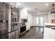 Well-lit kitchen features stainless steel appliances, white subway tile backsplash, and breakfast bar seating at 7608 Franklin Rd, Plant City, FL 33565