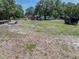 A grassy lot has several sheds and trailers at 7608 Franklin Rd, Plant City, FL 33565