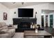 Cozy living room showcasing a black brick fireplace, hardwood floors, and natural lighting at 7608 Franklin Rd, Plant City, FL 33565
