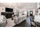 Spacious living room featuring a black brick fireplace, hardwood floors, and open layout to the kitchen at 7608 Franklin Rd, Plant City, FL 33565