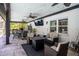 Covered patio with ceiling fans, TV, outdoor seating and dining area great for entertaining at 7608 Franklin Rd, Plant City, FL 33565