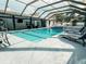 Beautiful pool with screened enclosure, hot tub, and poolside lounge chairs at 7608 Franklin Rd, Plant City, FL 33565