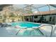 Inviting pool with a screened enclosure, hot tub, and ample seating for outdoor enjoyment at 7608 Franklin Rd, Plant City, FL 33565