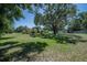 Wide shot of expansive yard featuring a large tree and plenty of room to enjoy at 7608 Franklin Rd, Plant City, FL 33565