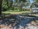 A view of a large grassy yard with shade trees, outbuildings and a house at 7608 Franklin Rd, Plant City, FL 33565