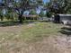 A large grassy yard surrounds a house with mature trees and a shed at 7608 Franklin Rd, Plant City, FL 33565