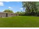 The expansive backyard boasts lush green grass, offering ample space for outdoor activities and relaxation at 1018 Briarwood Ave, Tampa, FL 33613