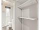 View of a bathroom, from the closet, with a toilet, vanity, and small window at 1018 Briarwood Ave, Tampa, FL 33613