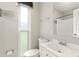 This bathroom has a white vanity with a mirror and a window, providing natural light at 1018 Briarwood Ave, Tampa, FL 33613