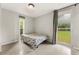 Inviting bedroom with large windows, providing ample natural light and views of the green outdoors at 1018 Briarwood Ave, Tampa, FL 33613