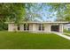 Charming single-story home with a well-maintained lawn and an attached carport at 1018 Briarwood Ave, Tampa, FL 33613