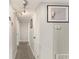Bright hallway with neutral walls and carpet leads to bedrooms, complete with modern track lighting at 1018 Briarwood Ave, Tampa, FL 33613