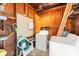 This laundry room is in an unfinished shed with a washer and dryer with storage shelving at 1018 Briarwood Ave, Tampa, FL 33613