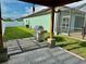 Backyard featuring patio, grill, green grass, and partial fence at 1201 Lavender Jewel Ct, Plant City, FL 33563