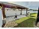 Backyard with gazebo, green grass, partial view of surrounding houses at 1201 Lavender Jewel Ct, Plant City, FL 33563