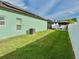 Backyard with green grass, a gazebo, and white fence at 1201 Lavender Jewel Ct, Plant City, FL 33563