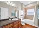 Neutral bathroom features a white vanity, dark countertops, bathtub, and tile backsplash at 1201 Lavender Jewel Ct, Plant City, FL 33563
