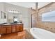Luxurious bathroom featuring a soaking tub and dual vanity at 1201 Lavender Jewel Ct, Plant City, FL 33563