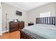 Bedroom featuring a full size bed, wood floors, and dresser at 1201 Lavender Jewel Ct, Plant City, FL 33563