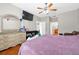 Bright bedroom featuring a dresser and a view to the bath and hallway at 1201 Lavender Jewel Ct, Plant City, FL 33563