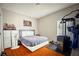 Bedroom with hardwood floors, dresser, and workout equipment at 1201 Lavender Jewel Ct, Plant City, FL 33563