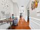 Inviting hallway featuring wood floors, white molding and decor at 1201 Lavender Jewel Ct, Plant City, FL 33563