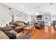 Comfortable living room with brown leather sofas and decorative tree art at 1201 Lavender Jewel Ct, Plant City, FL 33563