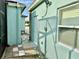 Side yard of house with walkway and aqua colored siding at 1201 Lavender Jewel Ct, Plant City, FL 33563