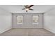 Spacious bedroom with ceiling fan, neutral carpet, and large windows at 2622 Lantern Hill Ave, Brandon, FL 33511