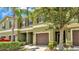 Exterior view of a townhome featuring manicured landscaping, a private entrance, and a attached garage at 2622 Lantern Hill Ave, Brandon, FL 33511