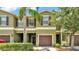Charming townhome with a well-maintained exterior, lush landscaping, and a private garage at 2622 Lantern Hill Ave, Brandon, FL 33511