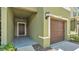 Inviting entryway with a covered porch and single car garage entrance at 2622 Lantern Hill Ave, Brandon, FL 33511