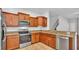 Modern kitchen features stainless appliances, tile floors, and granite counters at 2622 Lantern Hill Ave, Brandon, FL 33511