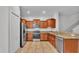 Contemporary kitchen featuring stainless steel appliances, tile flooring, and granite countertops at 2622 Lantern Hill Ave, Brandon, FL 33511
