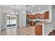 Modern kitchen with stainless steel appliances, granite countertops, and tile flooring and sliding glass doors at 2622 Lantern Hill Ave, Brandon, FL 33511