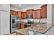 Stylish kitchen with stainless steel appliances, granite countertops, and ample cabinet space at 2622 Lantern Hill Ave, Brandon, FL 33511