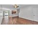 Spacious living room featuring hardwood floors and an open concept design leading to the kitchen at 2622 Lantern Hill Ave, Brandon, FL 33511